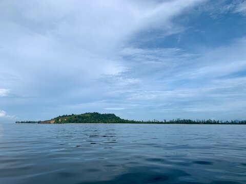 view from a distance of an island with the shape of a tablespoon