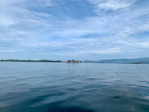 view from a distance of an island with the shape of a tablespoon