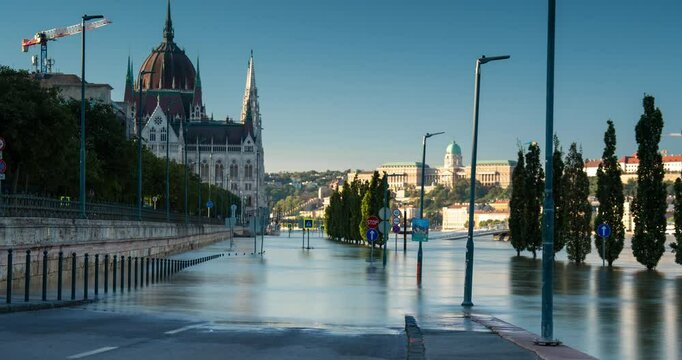Budapest, Hungary - September 22, 2024: Rising Waters Flood the Highway Outside Budapest's Parliament in the Aftermath of Storm 'Boris'. Timelapse, slide transition. Early morning.