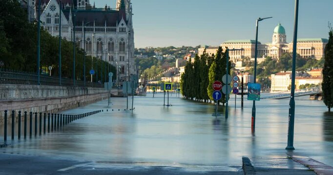 Budapest, Hungary - September 22, 2024: Rising Waters Flood the Highway Outside Budapest's Parliament in the Aftermath of Storm 'Boris'. Timelapse, zoom out transition. Early morning.