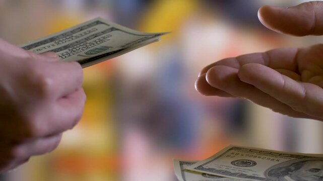 Man's hands ask and forcefully take cash money from woman's hands. Bribary concept
