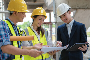Construction engineers discussion with architects at construction site or building site.