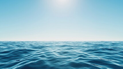 Obraz premium Tranquil ocean surface under a clear blue sky, radiating calmness and serenity, perfect for relaxation and travel themes.