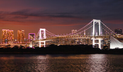 Fototapeta premium Rainbow Bridge at night, Odaiba, Tokyo, Japan. Tokyo bay landscape.