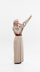 Hijabi Muslim woman confidently holding megaphone, raising her voice to inspire and lead. Empowerment and inclusion in the business world. Concept of business, dei, equality, support