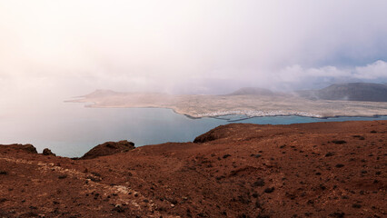picturesque view of Graciosa island with volcanic mountains at sundown in Teguise, Lanzarote at...