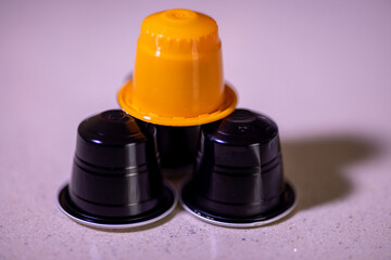 Assorted colorful coffee capsules in a detailed view on a white backdrop