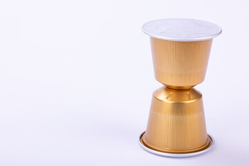 Golden Coffee Capsules on White Background
