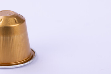 Golden Coffee Capsule on a White Background