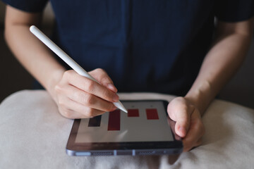 Hands holding tablet pen showing bar chart report business market growth digital technology, work from home online internet indoors, occupation manager signing contract signature planning finance
