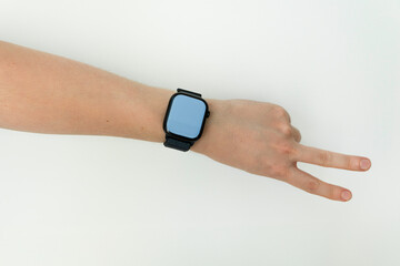 Fototapeta premium Young Male arm wearing and showing black smartwatch with blank screen isolated