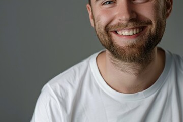 Fototapeta premium Smiling young man in white shirt showing healthy teeth.