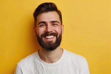 Obraz premium Smiling man in 30s with beard and mustache on yellow background