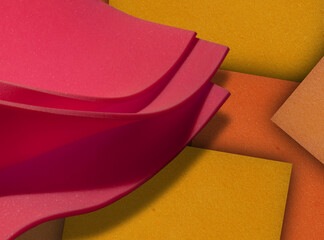 close-up view of thin pink foam material on orange rectangle material background