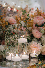 Elegant interior decor with white seating, golden candelabras, and floral arrangements