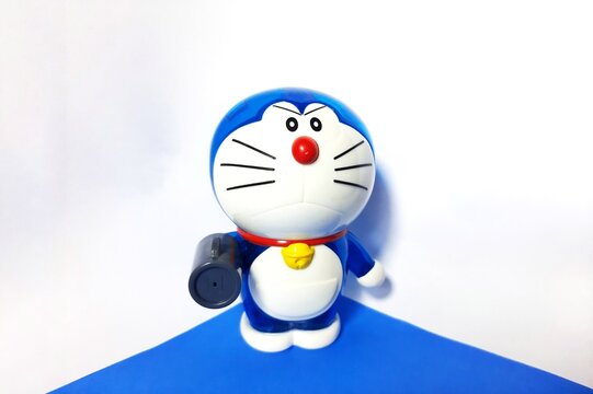 Jakarta, Indonesia July 21, 2023 doraemon with air canon gadget on a white background and blue base