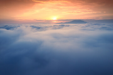 Sunrise shines over sea of fog in the morning