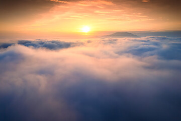 Sunrise shines over sea of fog in the morning