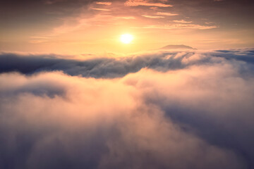 Sunrise shines over sea of fog in the morning