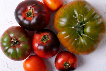 Assorted tomatoes of different colors and sizes. Top view. Food background
