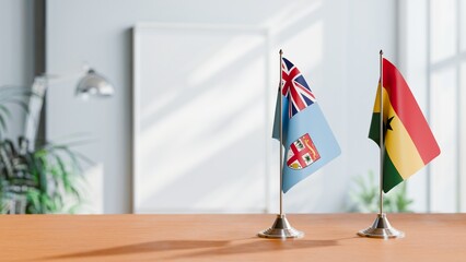 FLAGS OF FIJI AND GHANA ON TABLE