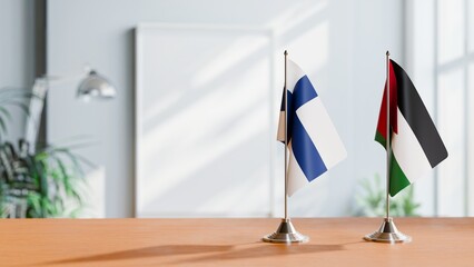 FLAGS OF FINLAND AND JORDAN ON TABLE