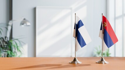 FLAGS OF FINLAND AND SERBIA ON TABLE