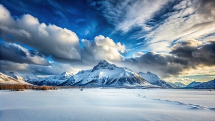 Snow-covered mountain peaks under a cloudy sky in a scenic landscape, mountains, snow, winter, clouds, sky, landscape