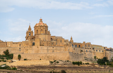 view of the old town of Mdina silent city in Malta island with stone church and medieval towers