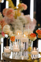 Elegant gold candelabras with lit candles and floral arrangements on a decorative table