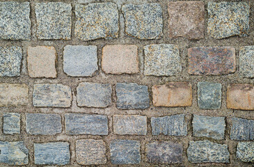 background of old building wall made of bricks of different colors