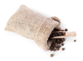 Burlap sack with allspice and scoop isolated on white, top view