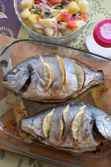 Bandeja con pescado al horno y bol con ensalada a la vinagreta
