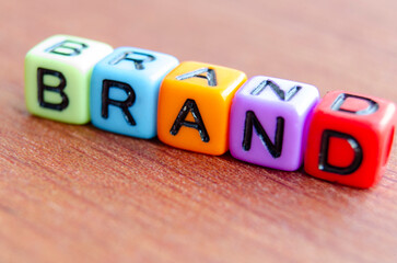 Brand text multicolor cubes on wooden table