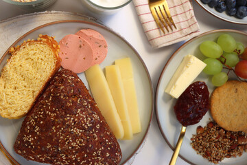 Assortment of various breakfast foods and drinks on the white table. Flat lay.