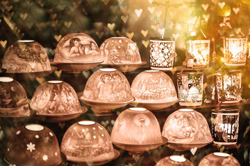 Many decorated Christmas lamps stand as decoration on a table against a blurred background. Christmas background.