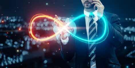 Businessman using mobile phone with infinity symbol connecting unlimited internet data usage 5G technology , limitless infinite data user storage cloud computing network security, city blue background