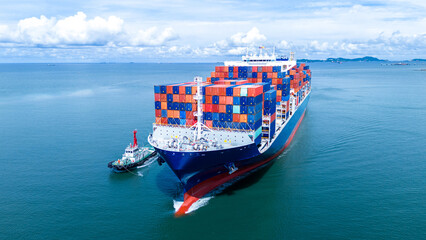 Front view of Cargo container ship carrying container and running out international container port...