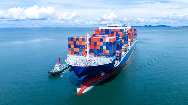 Front view of Cargo container ship carrying container and running out international container port customs shipyard sea port concept smart logistic service..