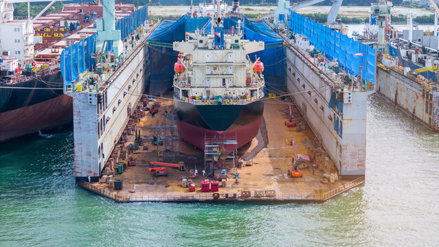 Oil tanker ship at dry dock concept maintenance service. working at dry dock. Insurance and Maintenance Crude tanker Ship concept. Freight Forwarding Service maintenance Insurance