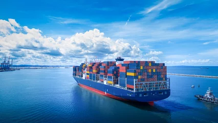 Stern view of Cargo container ship carrying container and running out international container port customs shipyard sea port concept smart logistic service..