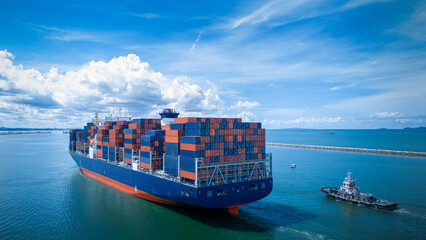 Fototapeta premium Stern view of Cargo container ship carrying container and running out international container port customs shipyard sea port concept smart logistic service..