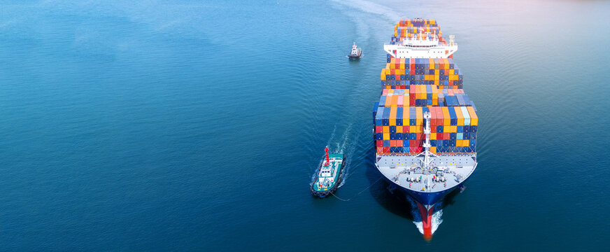 Front view of Cargo container ship carrying container and running out international container port customs shipyard sea port concept smart logistic service..