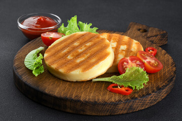 Grilled cheese with cherry tomatoes, chili pepper and lettuce salad