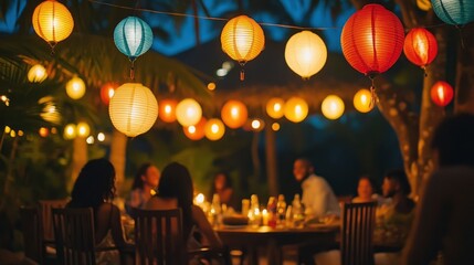 A festive outdoor gathering with brightly colored lanterns hanging above, illuminating happy faces.