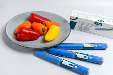  Ozempic Insulin injection pen for diabetics and weight loss and plate of vegetables