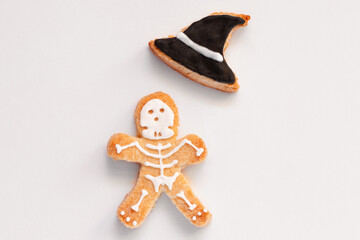 Halloween gingerbread cookies human shape witch hat on white background. Bright homemade cookies for Halloween party