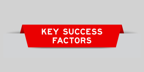 Red color inserted label with word key success factor on gray background