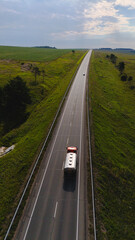 a truck is driving on the road view from a drone