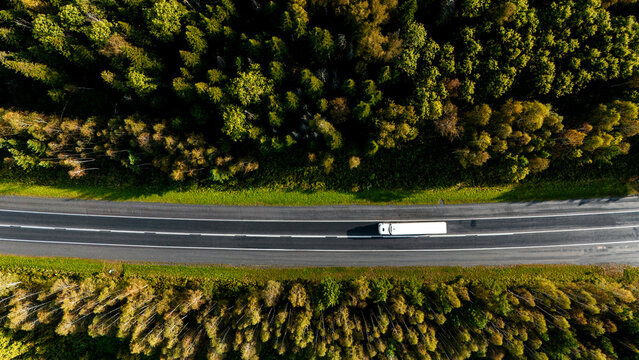 a truck is driving on the road view from a drone